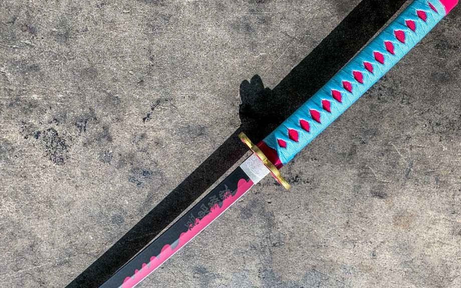 A pink and black replica blade with a teal wrapped handle