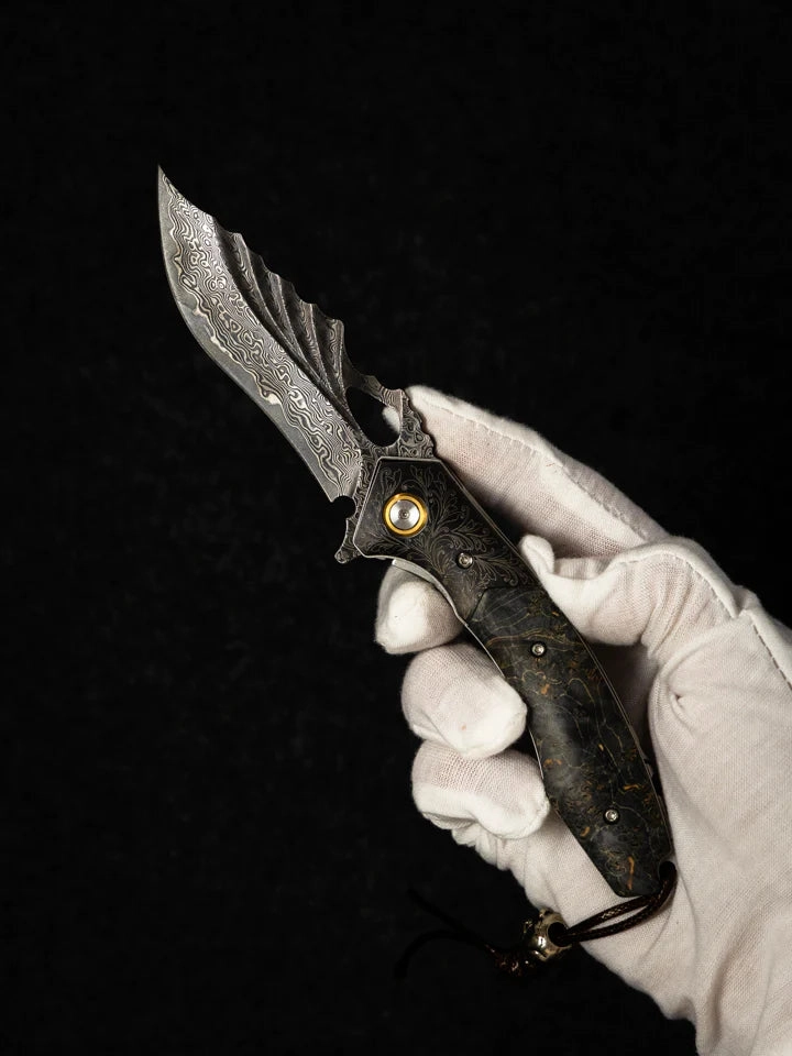 A gloved hand holding a Damascus pocket knife